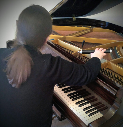 image of Rachel tuning a  piano tuning